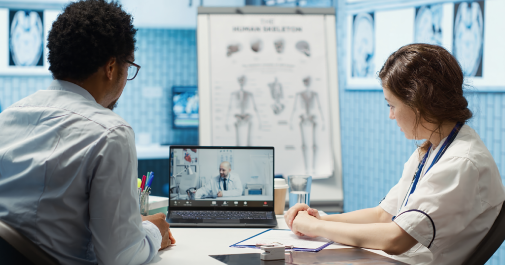 Doctors reviewing patient data and telemedicine platform analytics during virtual care session