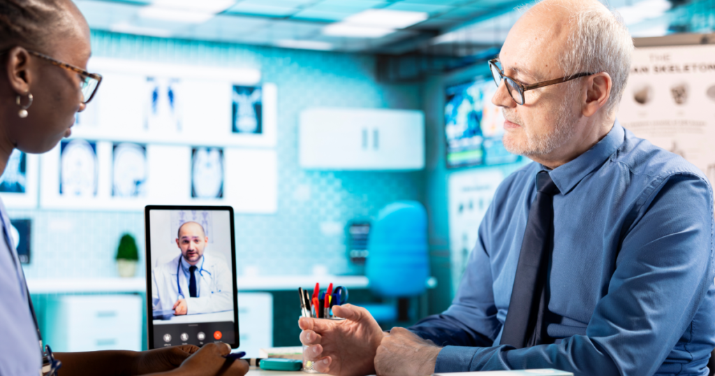 Elderly patient and healthcare provider reviewing telemedicine platform consultation on tablet — illustrating per-consultation pricing value for chronic disease management