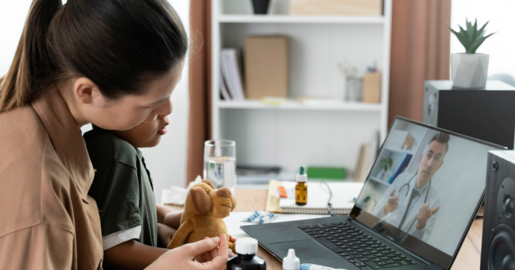 Mother and caregiver conducting a telehealth consultation with a doctor on a laptop — demonstrating telemedicine platform pricing value for home-based virtual care