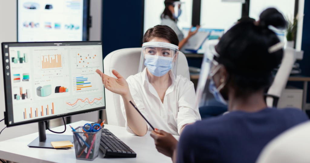 a doctor pointing towards a patient management software for virtual clinics